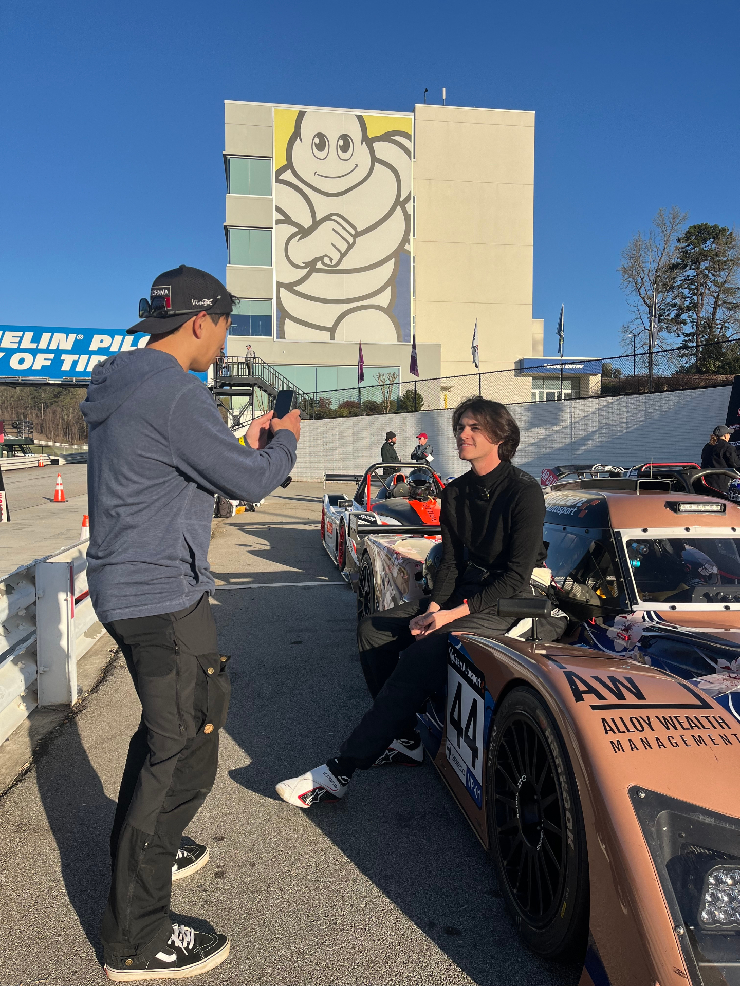 Creator filming a driver on-site at a local motorsports event